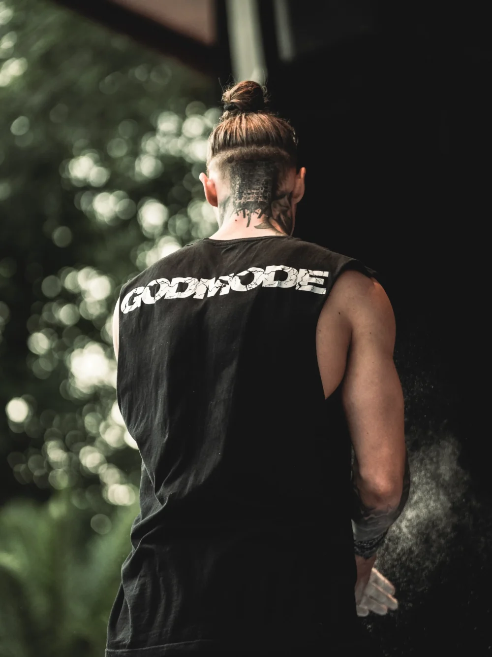 Daniels Laizans preparing for his set on a competition stage while wearing the RHSM Godmode Tank Top.