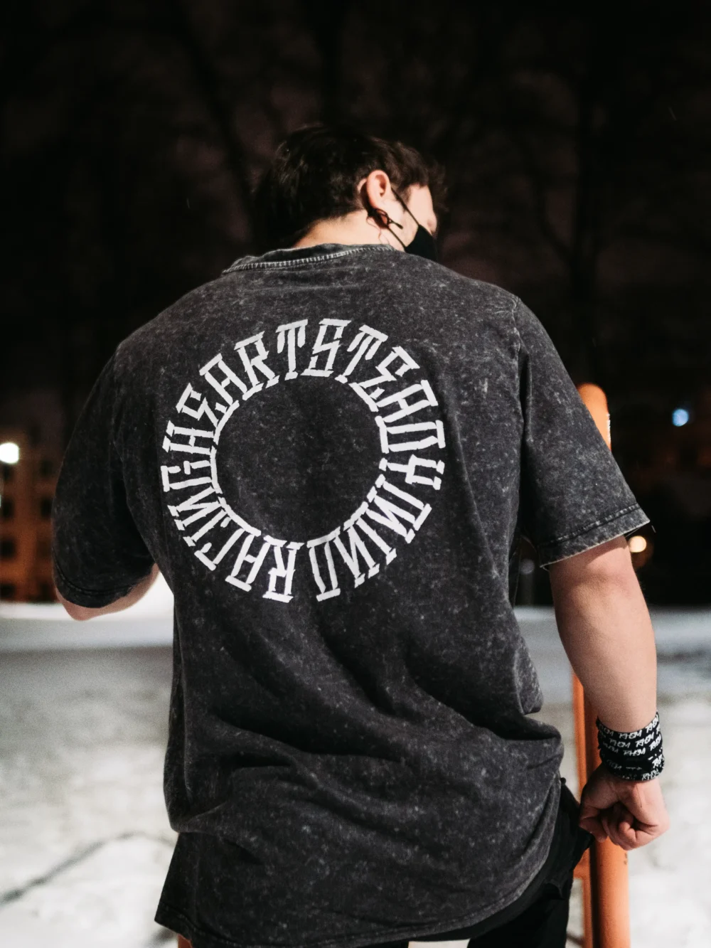 An athlete wearing the RHSM Acid Wash Tee outdoors, with a clear view of the back graphic.
