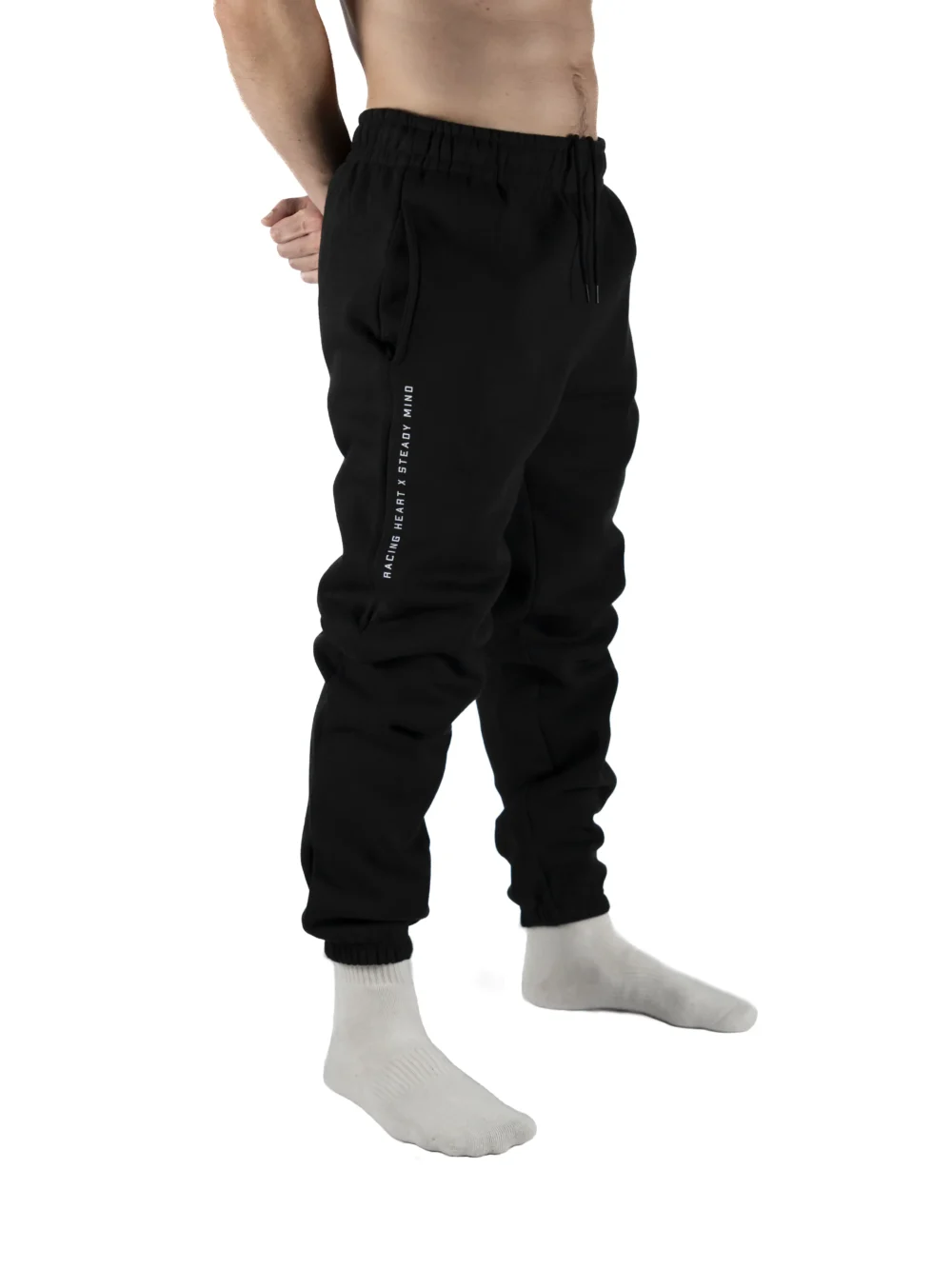 Front view of a model wearing the black RHSM Classic Fit Sweatpants, showing the comfortable athletic fit.