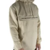 Front view of a model wearing the beige RHSM MVMT Hoodie, highlighting its oversized streetwear fit.