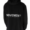Back view of a model wearing the black RHSM MVMT Hoodie, highlighting the designer-inspired "MOVEMENT" back graphic.
