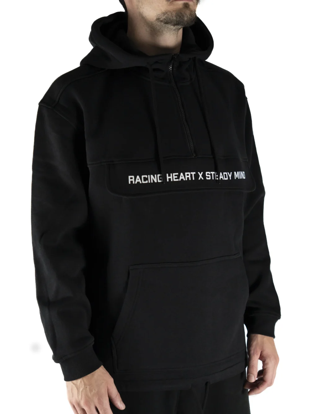 Front view of a model wearing the black RHSM MVMT Hoodie, showing its relaxed oversized fit.