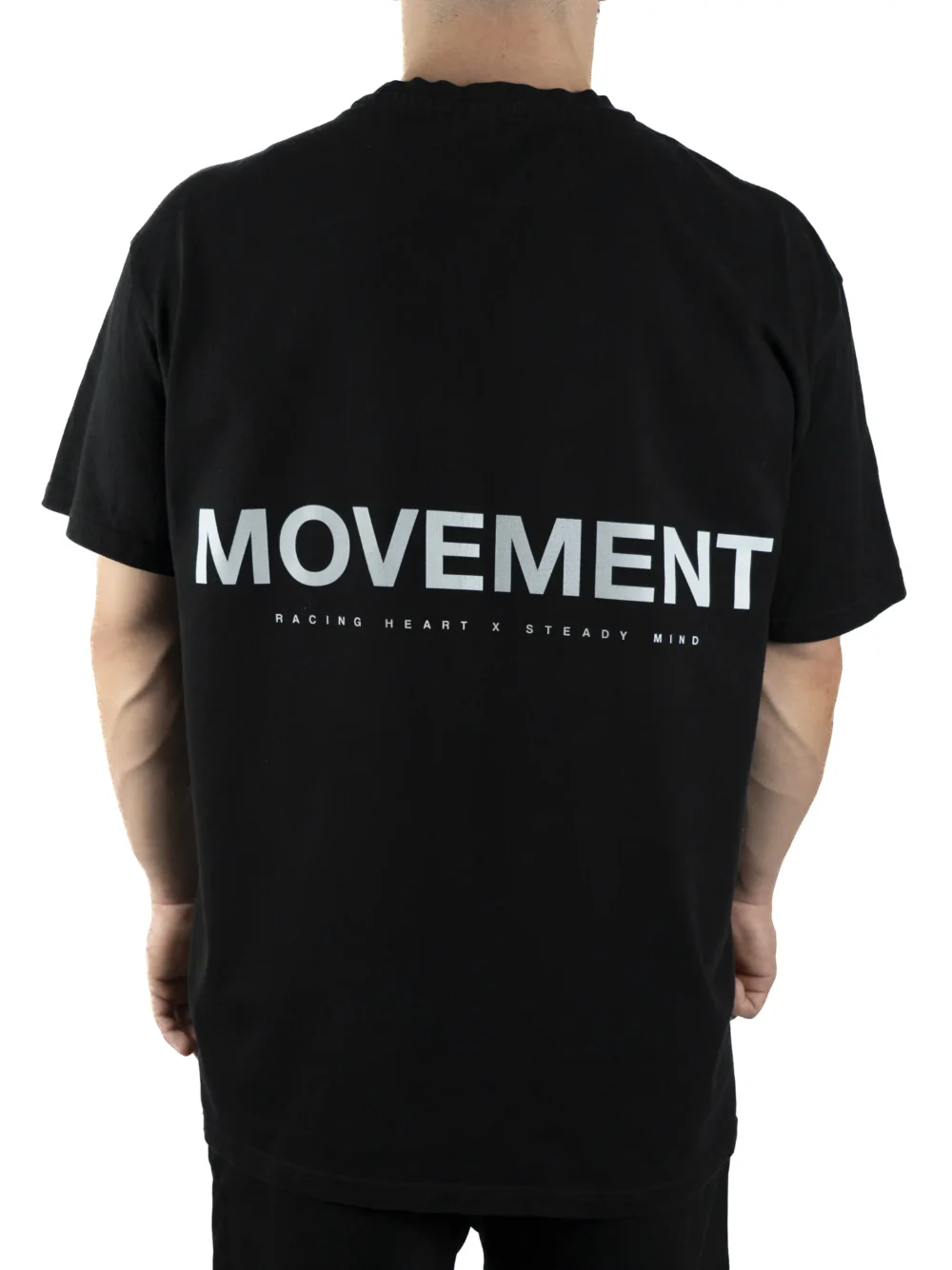 Back view of a model wearing the black RHSM Movement Tee, highlighting the designer-inspired back graphic.