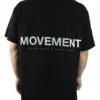 Back view of a model wearing the black RHSM Movement Tee, highlighting the designer-inspired back graphic.