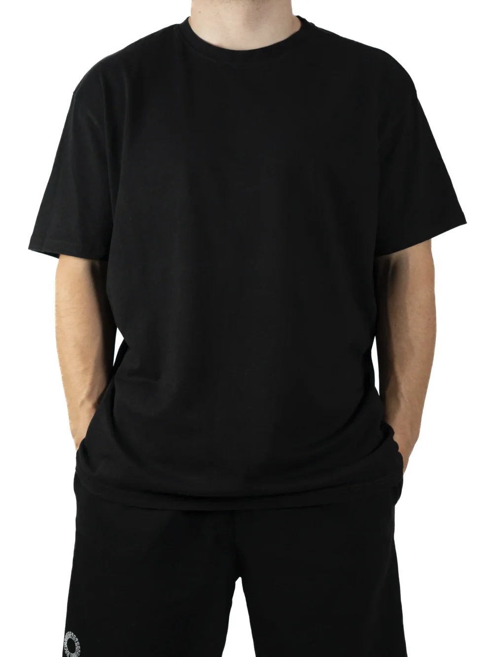 Front view of a model wearing the black RHSM Movement Tee, showing its oversized fit and dropped shoulders.