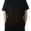 Front view of a model wearing the black RHSM Movement Tee, showing its oversized fit and dropped shoulders.
