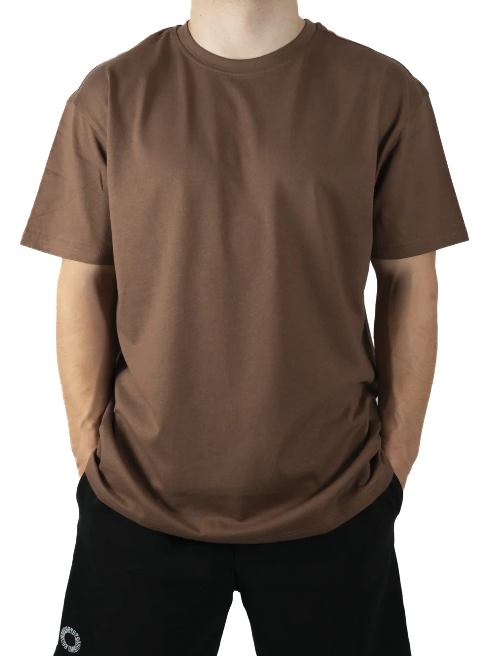 Front view of a model wearing the brown RHSM Movement Tee, showing its oversized fit and dropped shoulders.