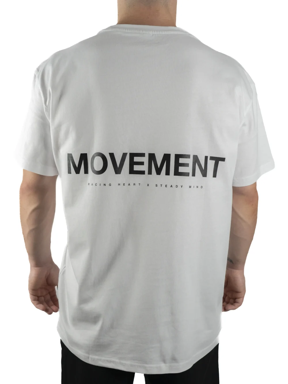 Back view of a model wearing the white RHSM Movement Tee, highlighting the designer-inspired back graphic.