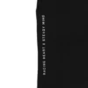 A close-up of the deep pocket and "Racing Heart X Steady Mind" graphic on the black RHSM Classic Fit Sweatpants.