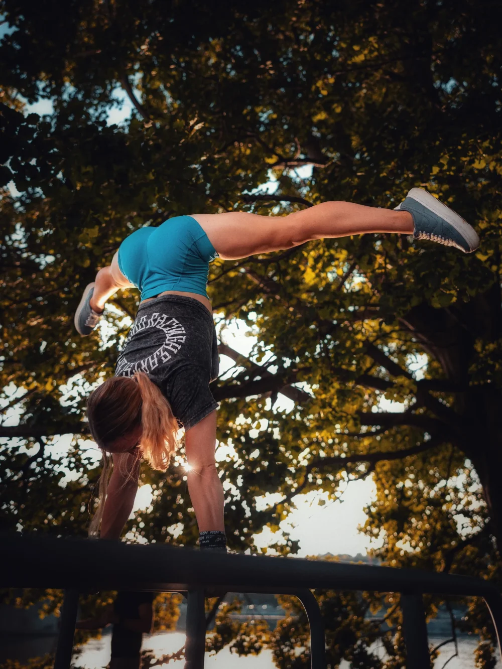 An athlete performing a handstand while wearing the RHSM Acid Wash Crop-Top, demonstrating its freedom of movement.