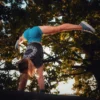 An athlete performing a handstand while wearing the RHSM Acid Wash Crop-Top, demonstrating its freedom of movement.
