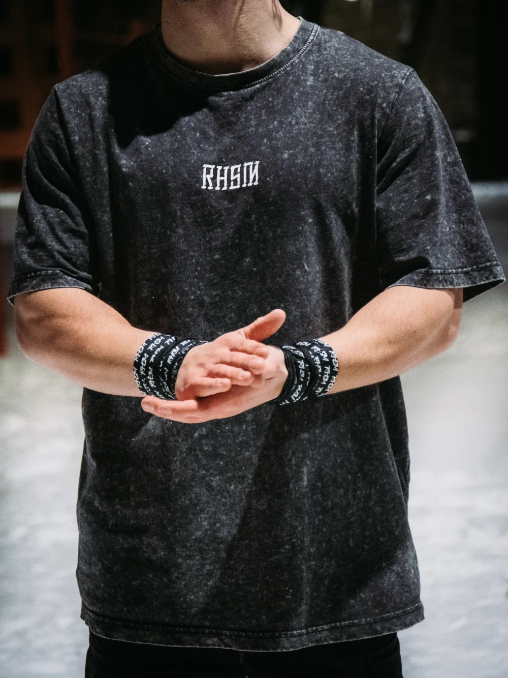 An athlete wearing the RHSM Acid Wash Tee outdoors, showcasing its comfortable oversized fit.
