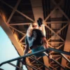 Back view of an athlete doing an l-sit in an urban setting, wearing the stylish RHSM Acid Wash Crop-Top.