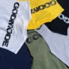 A stack of all available colorways of the RHSM Godmode Tank Top, including black, white, gray, khaki, blue, and yellow.