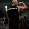 An athlete wearing the black RHSM Godmode Tank Top during an intense gym training session.