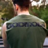 Back view of an athlete wearing the khaki RHSM Godmode Tank Top during an outdoor street workout.