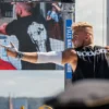 A calisthenics competitor wearing the RHSM Godmode Tank Top on stage during a competition.