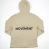 The back of the beige RHSM MVMT Hoodie laid flat, showcasing the minimalist "MOVEMENT" back graphic.
