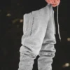 A full side view of a model wearing the gray RHSM Classic Fit Sweatpants outdoors, showcasing the modern silhouette.
