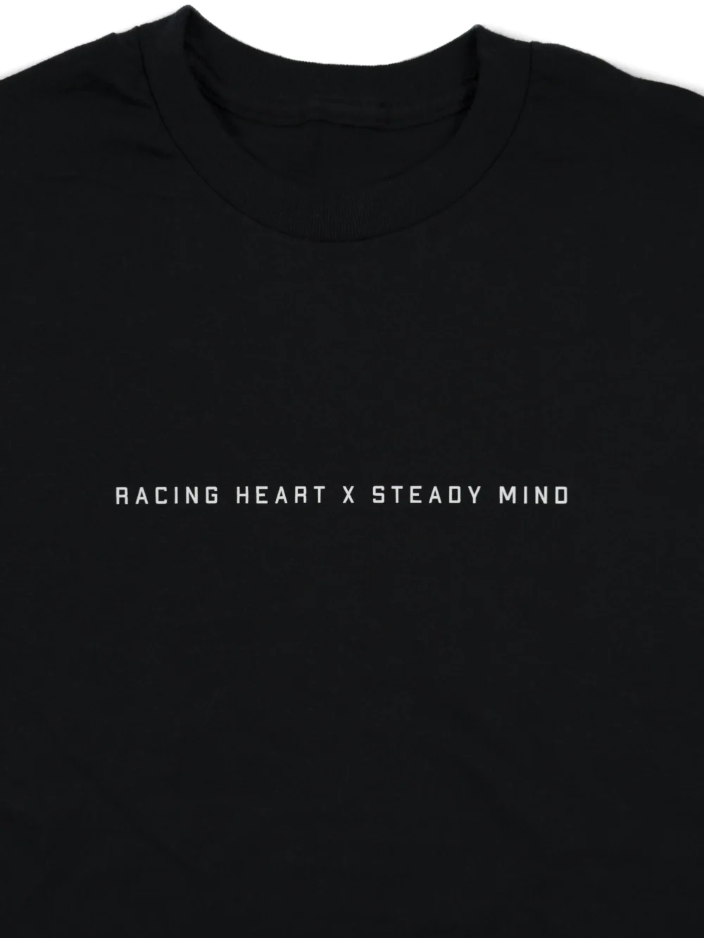 A close-up of the subtle front graphic on the black RHSM Classic Fit Tee.