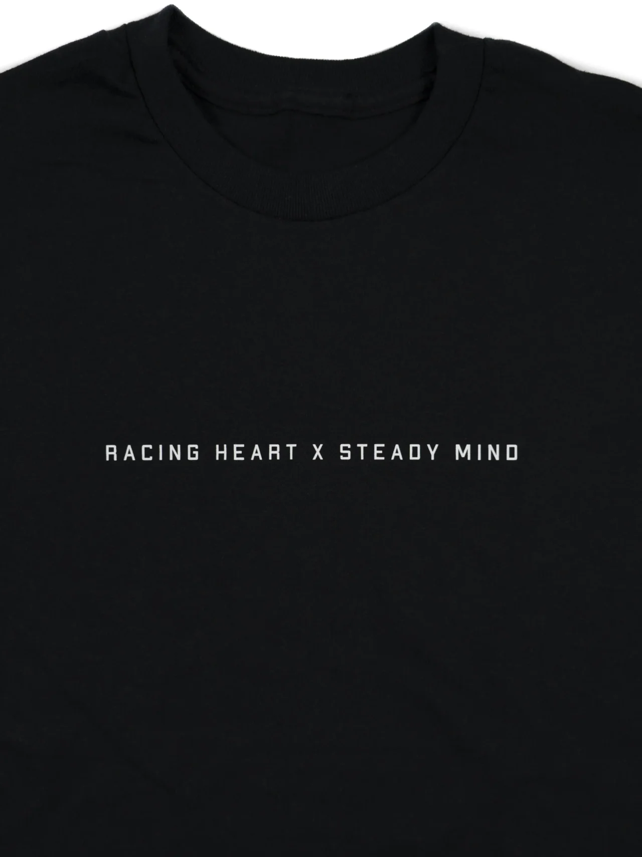 A close-up of the subtle front graphic on the black RHSM Classic Fit Tee.