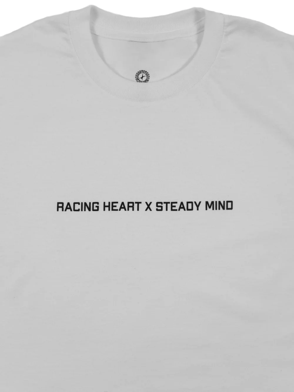 A close-up of the subtle front graphic on the white RHSM Classic Fit Tee.