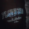 Close-up of the RHSM Flowstate Hoodie's durable fabric being worn in an outdoor calisthenics park.