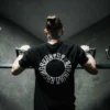 Calisthenics champion Daniels Laizans performing a pull-up while wearing the black RHSM Long Fit Tee V2.