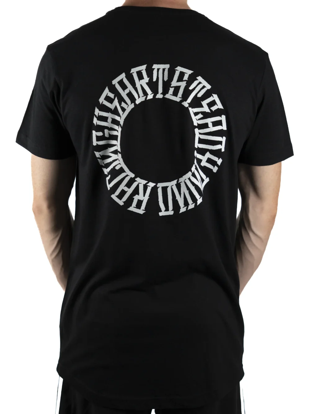 Back view of a model wearing the black RHSM Long Fit Tee V2, showing the "Racing Heart Steady Mind" graphic.