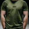 Model wearing the khaki RHSM Long Fit Tee V2 outside, showcasing its modern streetwear style.