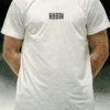 Model wearing the white RHSM Long Fit Tee V2 outside, showcasing its modern and clean streetwear style.