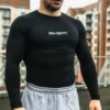 Front view of an athlete wearing the black RHSM Compression Shirt in an outdoor training setting.
