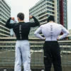 Two models posing in the RHSM Compression Shirts against a cityscape background.