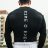 A close-up of the back of the black RHSM Compression Shirt, showing the fabric and fit on a model.