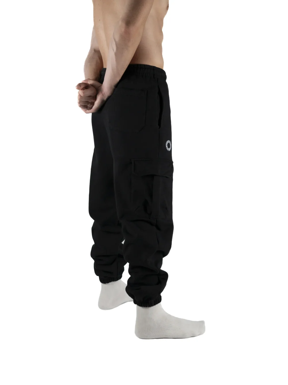 Back view of a model wearing the black RHSM Cargo Sweatpants.