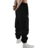 Back view of a model wearing the black RHSM Cargo Sweatpants.