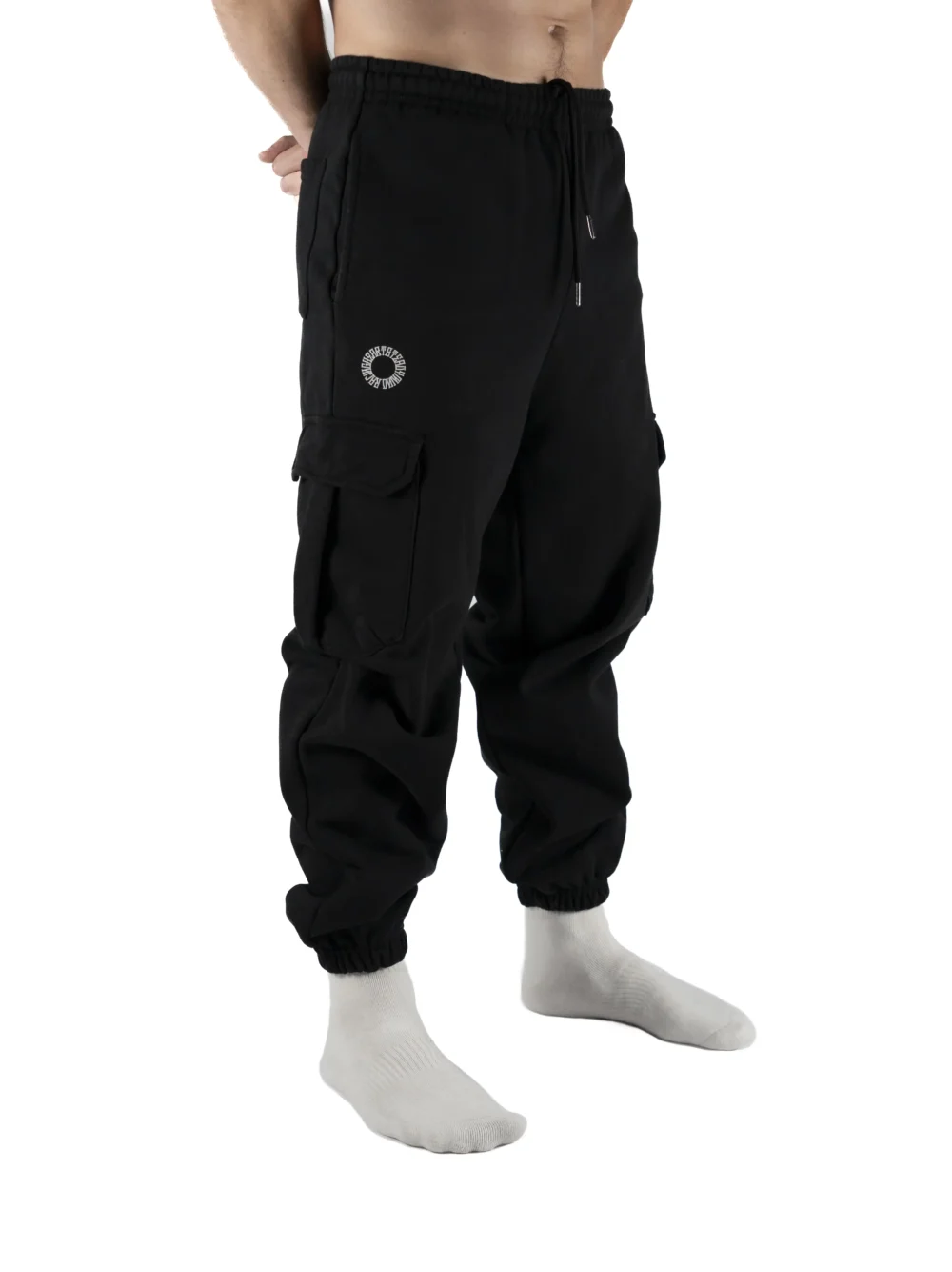 Front view of a model wearing the black RHSM Cargo Sweatpants, showing their fit for training and streetwear.
