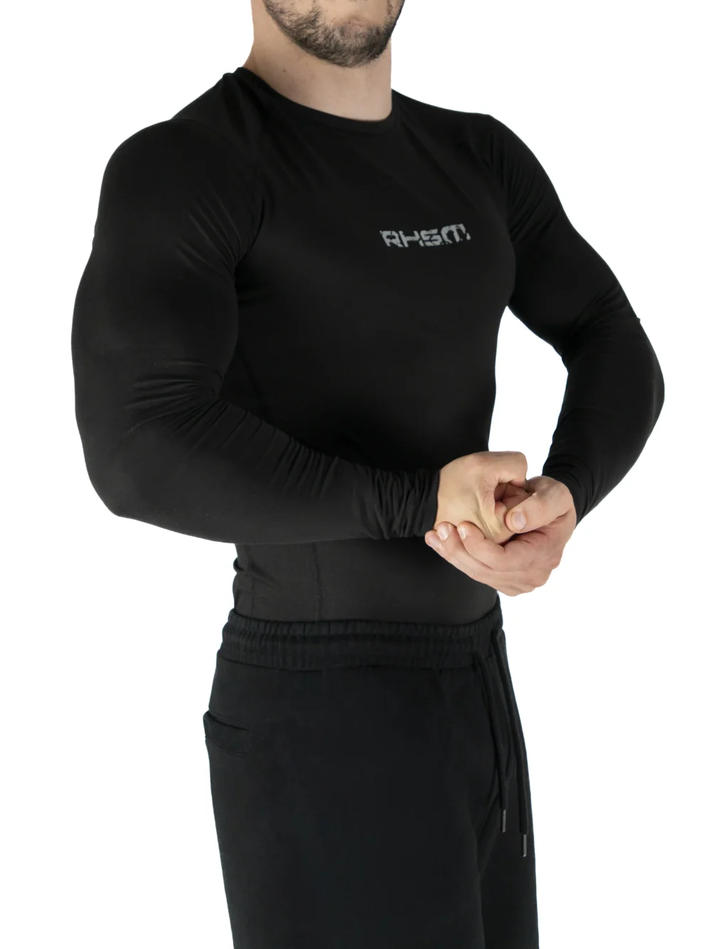 Front view of a model wearing the black RHSM Compression Shirt, showing its supportive fit.