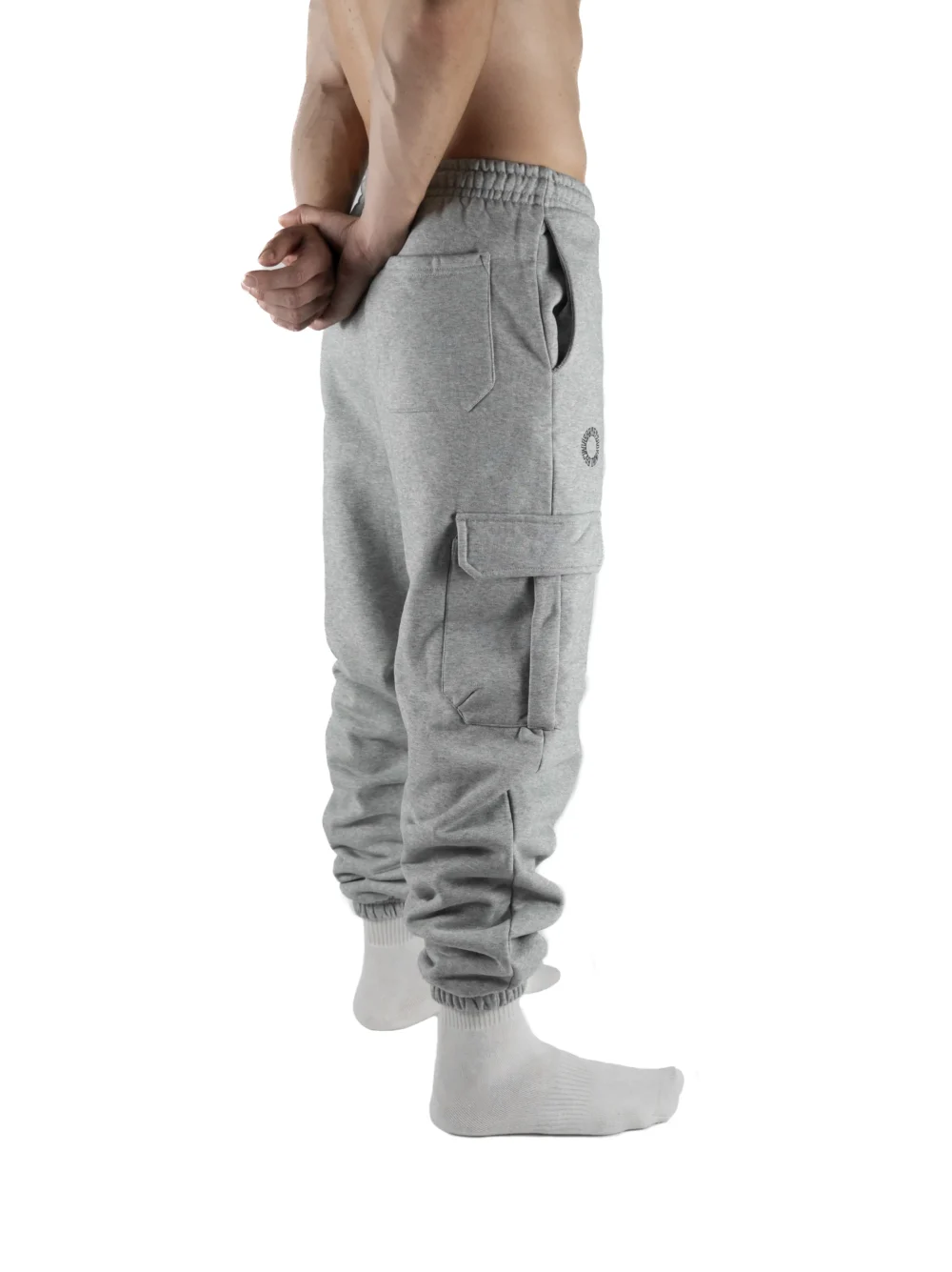 Back view of a model wearing the gray RHSM Cargo Sweatpants.