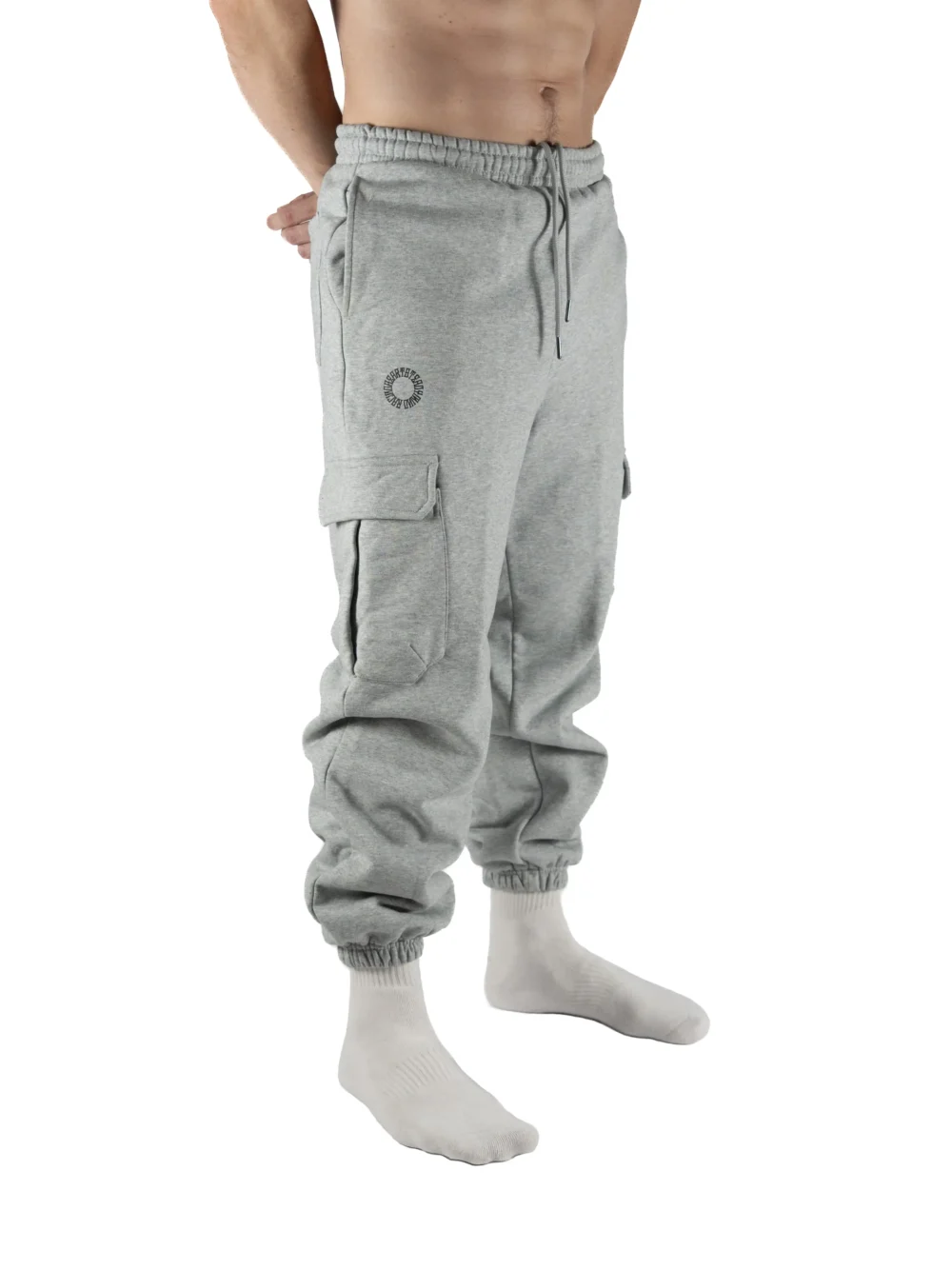 Front view of a model wearing the gray RHSM Cargo Sweatpants, showing their fit for training and streetwear.