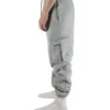 Side view of a model wearing the gray RHSM Cargo Sweatpants, showcasing the functional side cargo pocket.