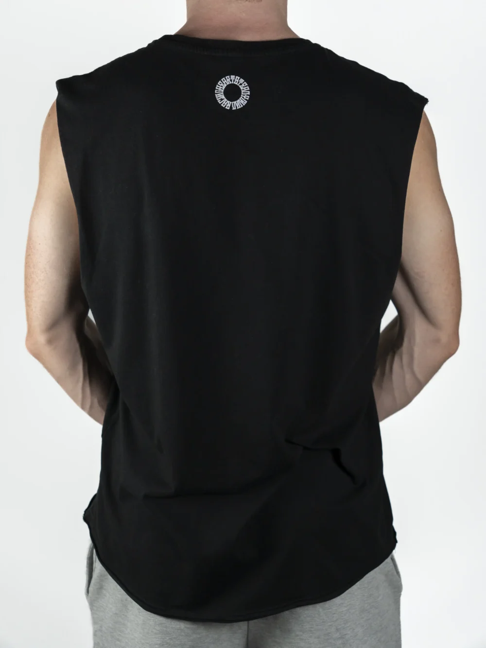 Back view of a model wearing the black RHSM Flowstate Tank Top, showing the cut-off style that allows for unrestricted movement during muscle-ups.