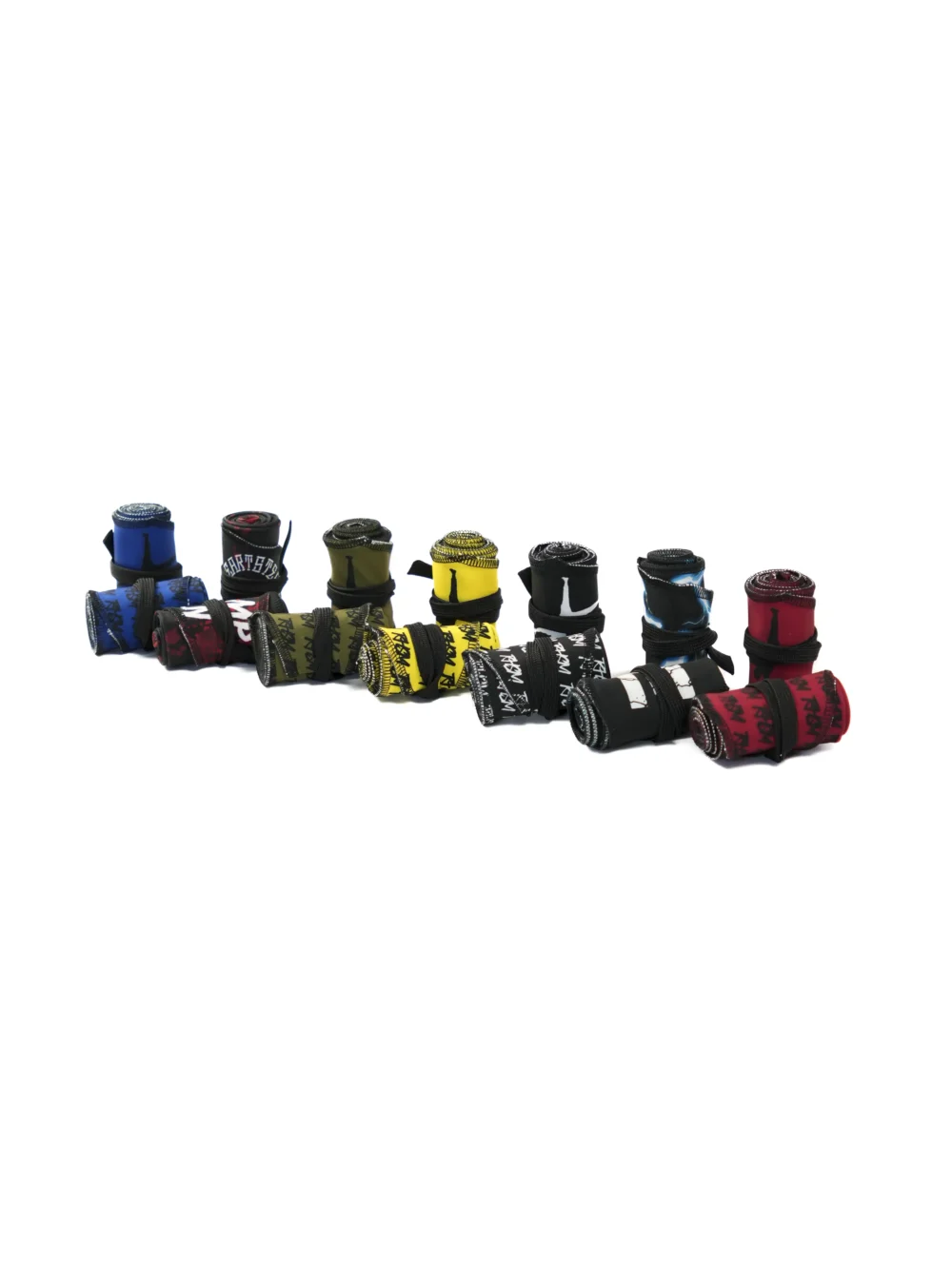 All colorways of the RHSM Calisthenics Wrist Wraps V2 rolled up together, including black, blue, red, yellow, and khaki.