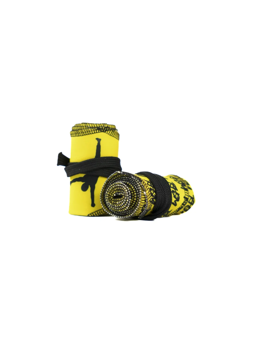A close-up of the yellow RHSM Calisthenics Wrist Wraps V2, rolled up and ready for a workout.