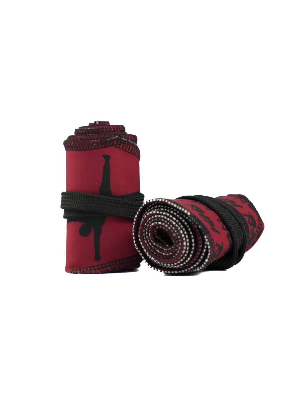 A close-up of the red RHSM Calisthenics Wrist Wraps V2, rolled up and ready for a workout.
