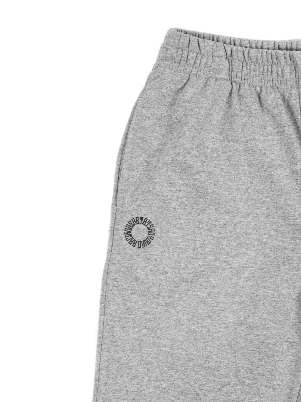 Closeup of the embroidered RHSM First Edition emblem on the pocket of the gray sweatpants.