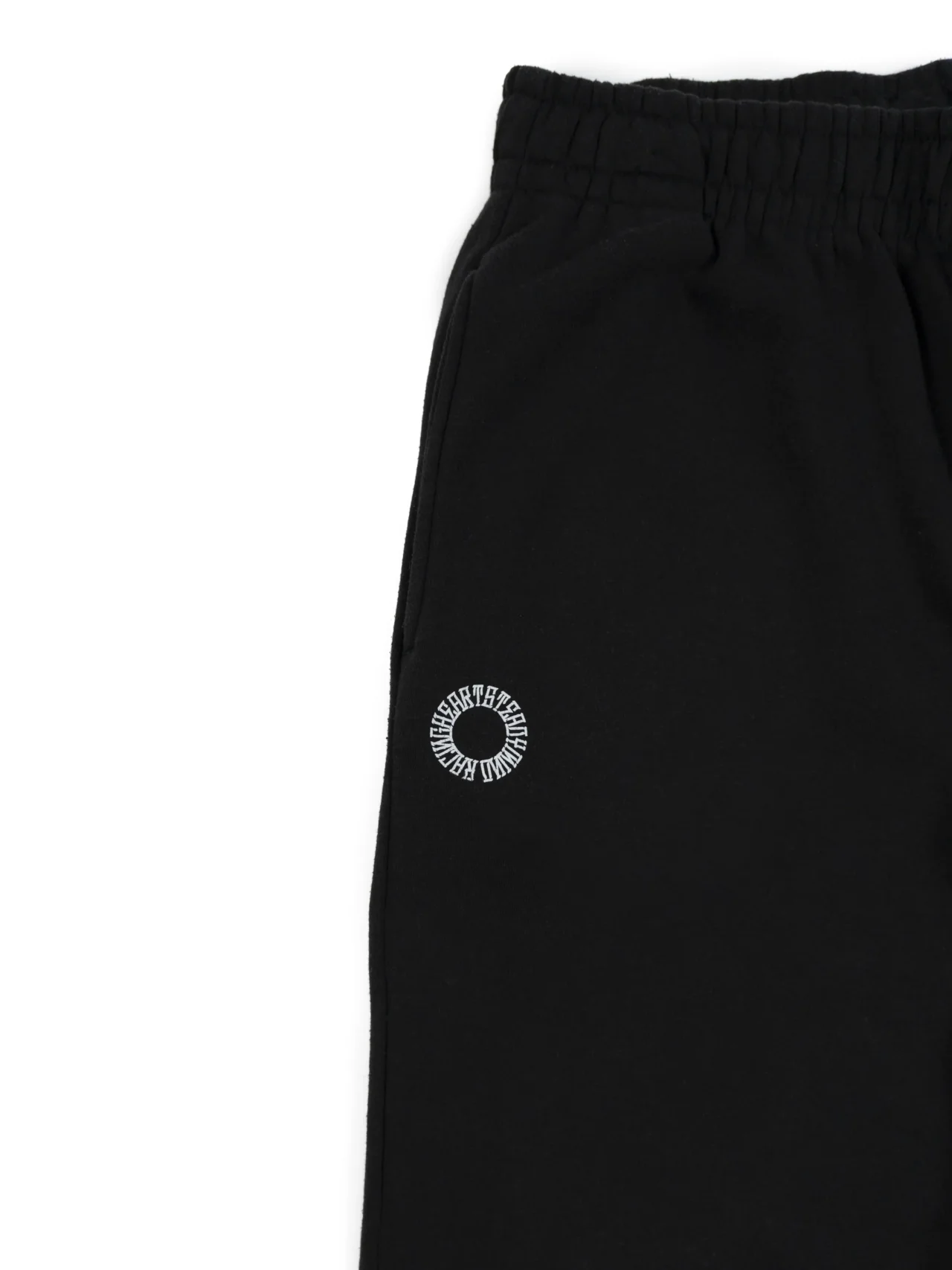 Closeup of the embroidered RHSM First Edition emblem on the pocket of the black sweatpants.