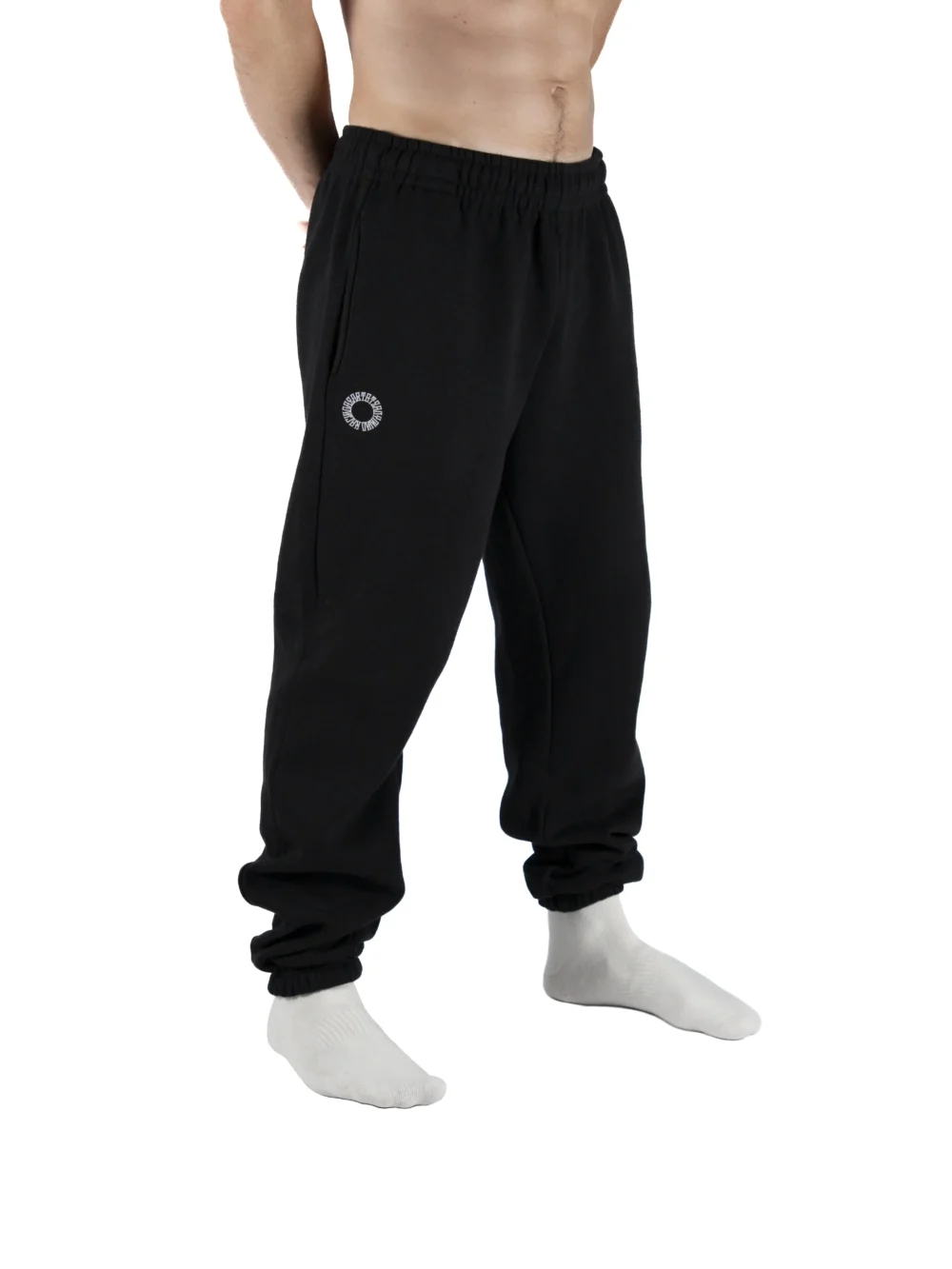 Male model wearing the black RHSM First Edition sweatpants, showing the relaxed oversized fit from the front.