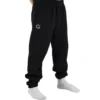 Male model wearing the black RHSM First Edition sweatpants, showing the relaxed oversized fit from the front.