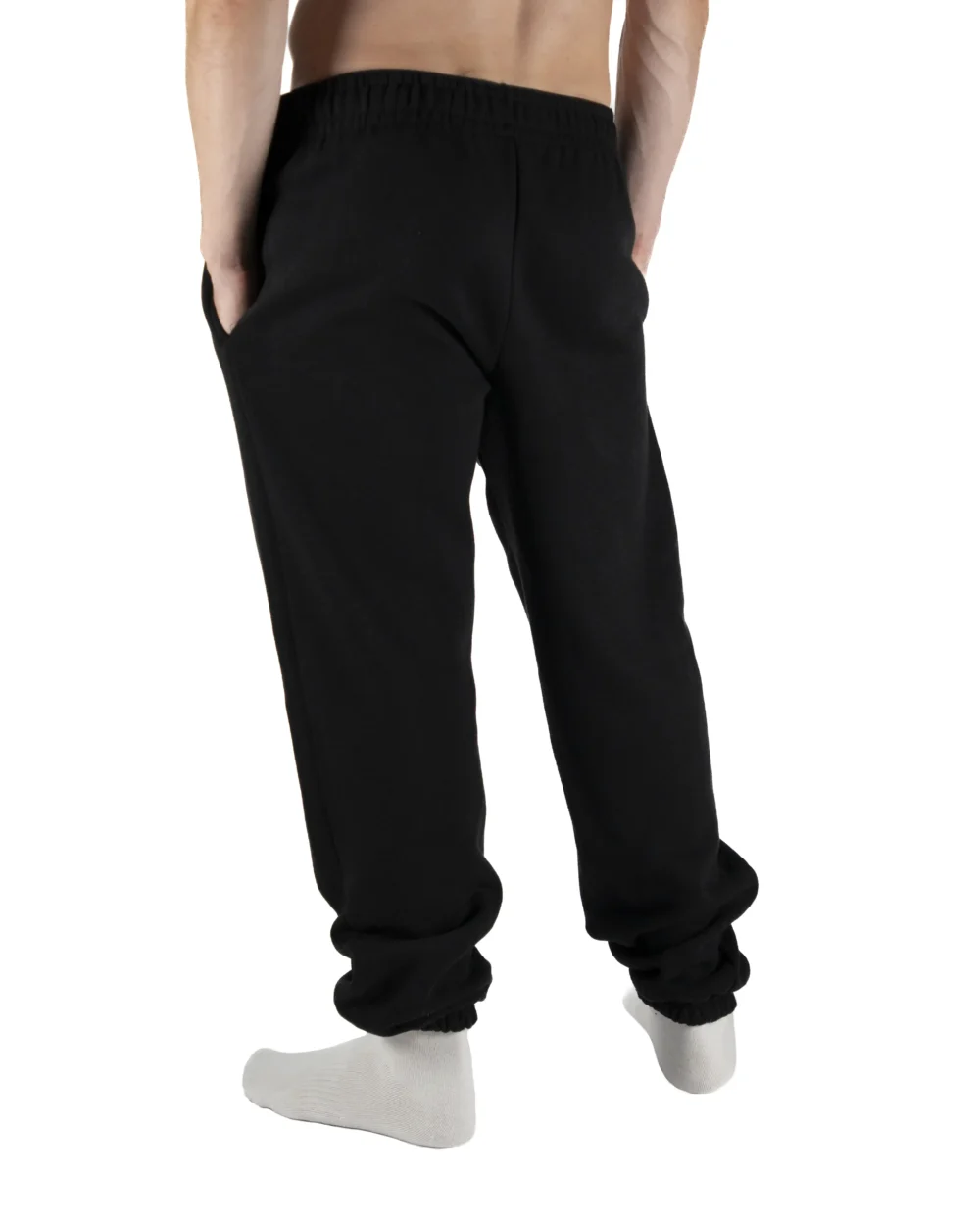 Male model wearing the black RHSM First Edition sweatpants, showing the fit and silhouette from the back.